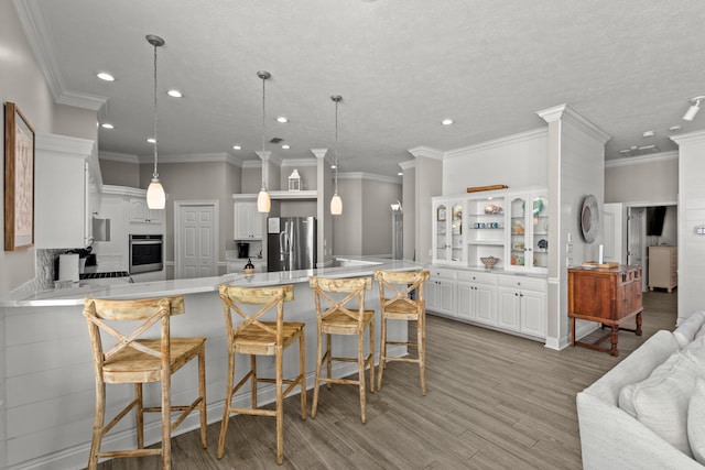 72 Tranquility Ln, Destin, FL 32541 - kitchen featuring stainless steel appliances, a peninsula, recessed lighting, light countertops, and a breakfast bar