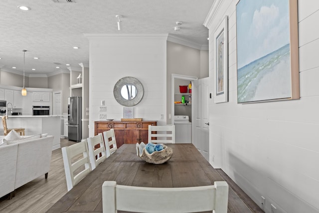 72 Tranquility Ln, Destin, FL 32541 - dining space featuring wood finished floors, recessed lighting, crown molding, and washer / clothes dryer