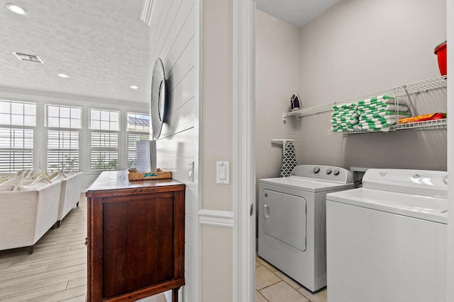 72 Tranquility Ln, Destin, FL 32541 - laundry room with washer and dryer, a textured ceiling, and recessed lighting