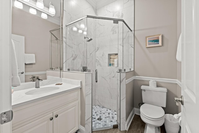 72 Tranquility Ln, Destin, FL 32541 - bathroom featuring vanity, toilet, a marble finish shower, baseboards, and ornamental molding