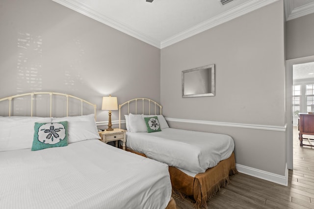 72 Tranquility Ln, Destin, FL 32541 - bedroom with baseboards, ornamental molding, and wood finished floors