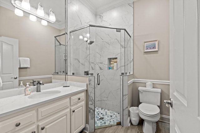 72 Tranquility Ln, Destin, FL 32541 - full bathroom featuring ornamental molding, toilet, vanity, a marble finish shower, and wood finished floors