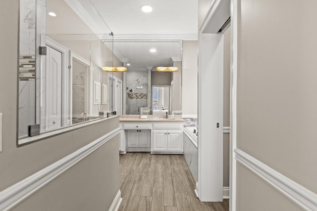 72 Tranquility Ln, Destin, FL 32541 - full bathroom with double vanity, crown molding, an enclosed shower, wood finished floors, and recessed lighting