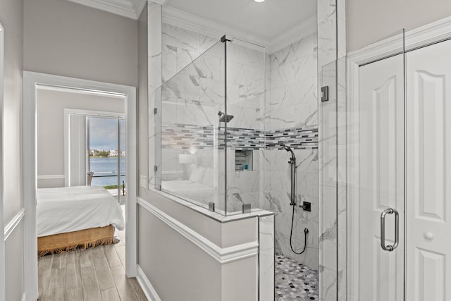 72 Tranquility Ln, Destin, FL 32541 - bathroom featuring a marble finish shower, a water view, ornamental molding, wood finished floors, and ensuite bath