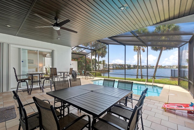 72 Tranquility Ln, Destin, FL 32541 - view of patio featuring outdoor dining space, a water view, an outdoor pool, and glass enclosure