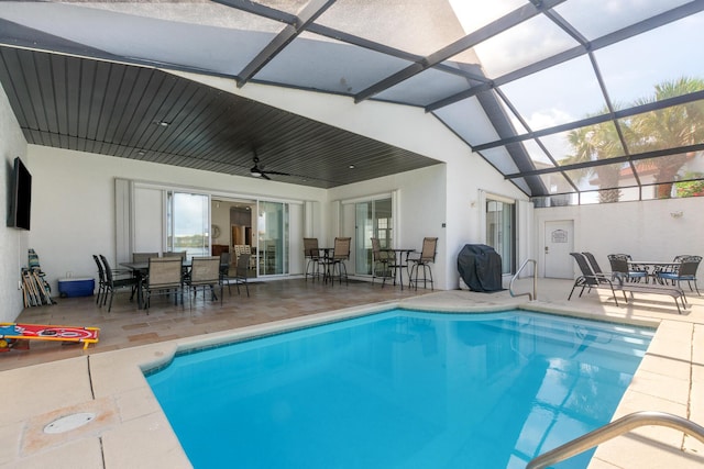 72 Tranquility Ln, Destin, FL 32541 - swimming pool with outdoor dining space, a patio, a ceiling fan, and glass enclosure