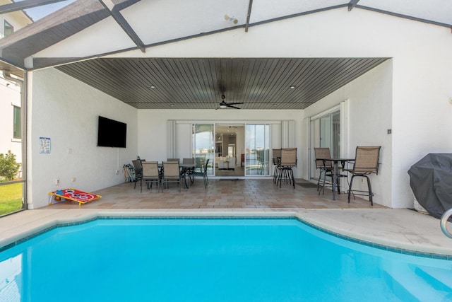 72 Tranquility Ln, Destin, FL 32541 - swimming pool with ceiling fan, a patio, outdoor dining space, and glass enclosure