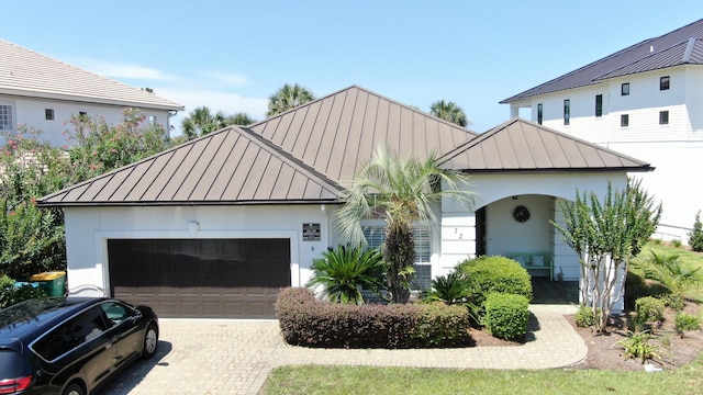 72 Tranquility Ln, Destin, FL 32541 - view of front of house with a standing seam roof, metal roof, and decorative driveway