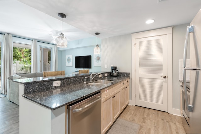 9200 Baytowne Wharf Blvd Unit 341, Miramar Beach, FL 32550 - kitchen with dishwasher, a sink, a peninsula, light wood-type flooring, and hanging light fixtures