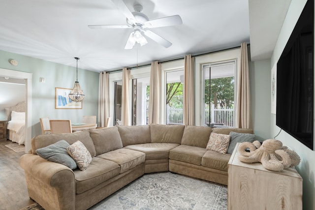 9200 Baytowne Wharf Blvd Unit 341, Miramar Beach, FL 32550 - living room with ceiling fan, light wood-type flooring, and a chandelier