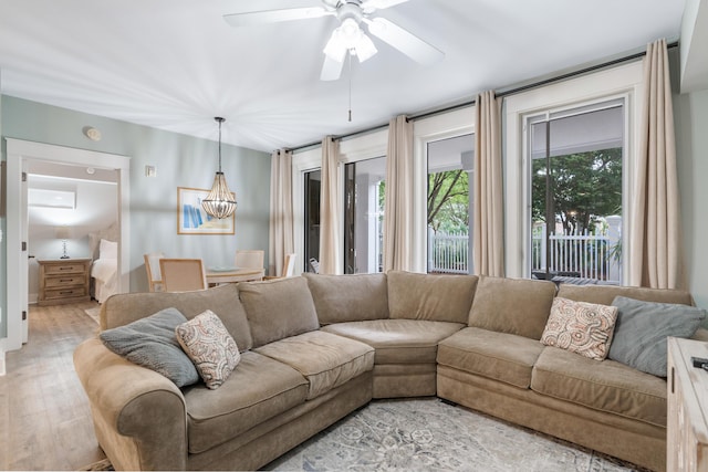 9200 Baytowne Wharf Blvd Unit 341, Miramar Beach, FL 32550 - living room featuring light wood-type flooring, a ceiling fan, and a chandelier