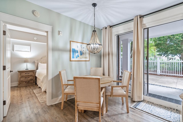 9200 Baytowne Wharf Blvd Unit 341, Miramar Beach, FL 32550 - dining area featuring a chandelier, light wood-type flooring, and baseboards