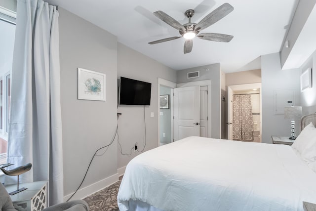 9200 Baytowne Wharf Blvd Unit 341, Miramar Beach, FL 32550 - bedroom featuring baseboards, a ceiling fan, connected bathroom, and electric panel
