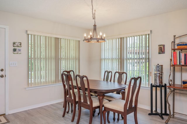 642 Alysheba Dr, Crestview, FL 32539 - dining space with healthy amount of natural light, a chandelier, light wood-type flooring, and baseboards