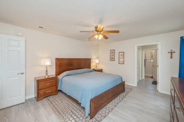 642 Alysheba Dr, Crestview, FL 32539 - bedroom featuring light wood-style floors, baseboards, a textured ceiling, and ceiling fan