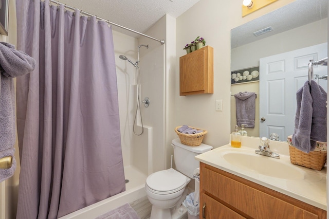 642 Alysheba Dr, Crestview, FL 32539 - full bath with toilet, a shower with shower curtain, vanity, a textured ceiling, and wood finished floors
