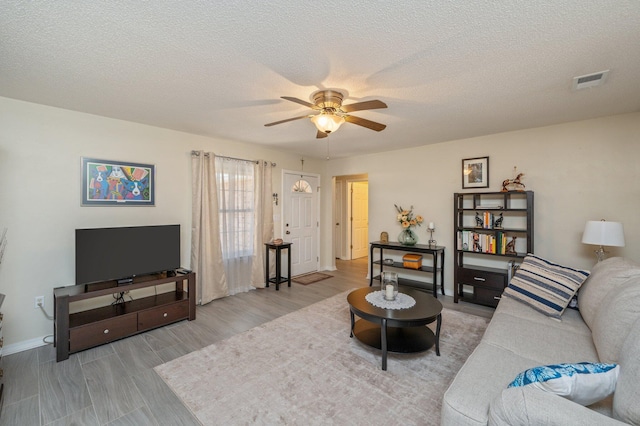 642 Alysheba Dr, Crestview, FL 32539 - living area with ceiling fan, baseboards, wood finished floors, and a textured ceiling