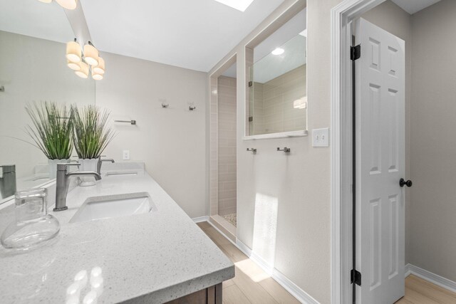 112 Meigs Dr, Shalimar, FL 32579 - full bathroom featuring double vanity, wood finished floors, a walk in shower, and baseboards
