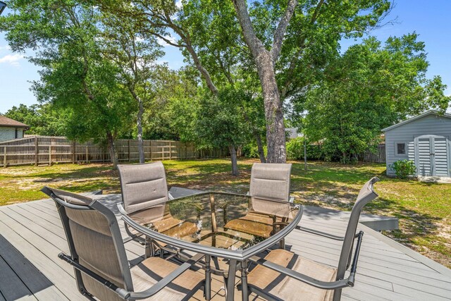 112 Meigs Dr, Shalimar, FL 32579 - deck with outdoor dining space and an outbuilding