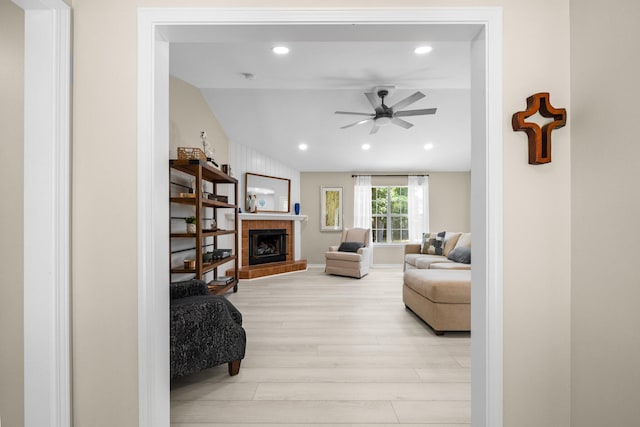 112 Meigs Dr, Shalimar, FL 32579 - living area featuring light wood-style floors, ceiling fan, vaulted ceiling, a tiled fireplace, and recessed lighting