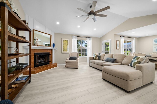 112 Meigs Dr, Shalimar, FL 32579 - living area featuring light wood-type flooring, lofted ceiling, a ceiling fan, plenty of natural light, and a tile fireplace