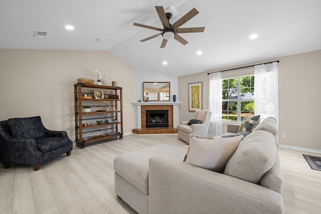 112 Meigs Dr, Shalimar, FL 32579 - living area with ceiling fan, lofted ceiling, light wood-type flooring, a tiled fireplace, and recessed lighting