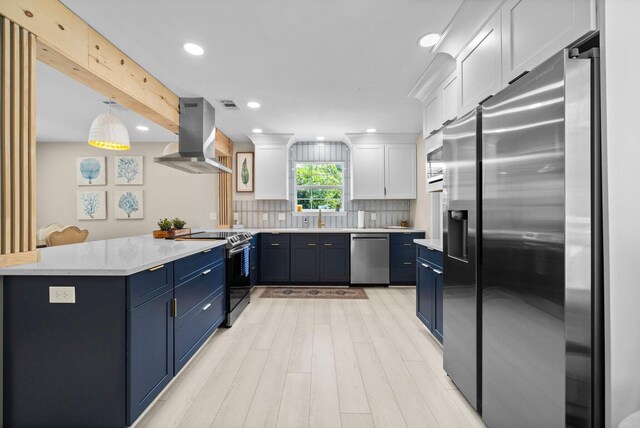 112 Meigs Dr, Shalimar, FL 32579 - kitchen featuring appliances with stainless steel finishes, blue cabinets, island range hood, a peninsula, and recessed lighting