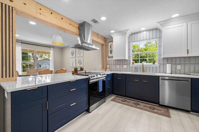 112 Meigs Dr, Shalimar, FL 32579 - kitchen featuring appliances with stainless steel finishes, a sink, a peninsula, island range hood, and white cabinets