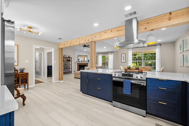 112 Meigs Dr, Shalimar, FL 32579 - kitchen featuring stainless steel appliances, island exhaust hood, blue cabinets, light countertops, and recessed lighting
