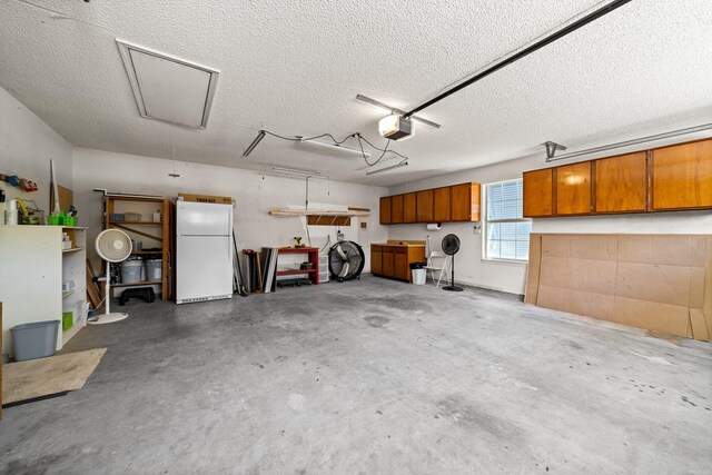 112 Meigs Dr, Shalimar, FL 32579 - garage with freestanding refrigerator and a garage door opener