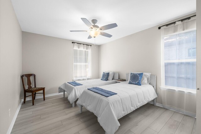 112 Meigs Dr, Shalimar, FL 32579 - bedroom with light wood-style flooring, baseboards, and a ceiling fan