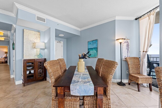 16819 Front Beach Rd Unit 2300, Panama City Beach, FL 32413 - dining area featuring crown molding, light tile patterned floors, and baseboards