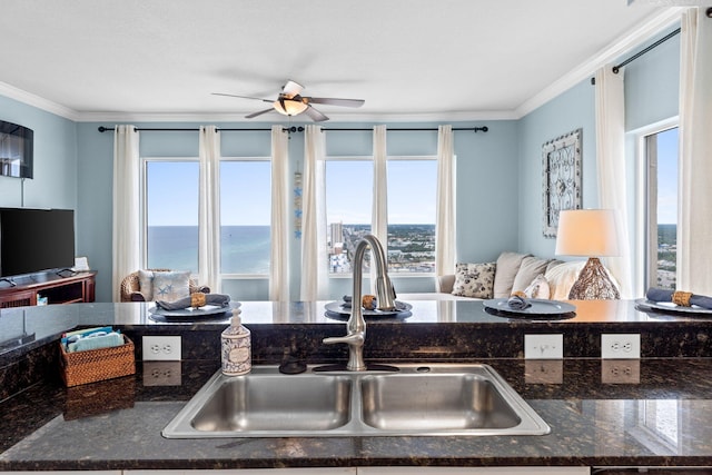 16819 Front Beach Rd Unit 2300, Panama City Beach, FL 32413 - kitchen featuring a sink, open floor plan, crown molding, ceiling fan, and dark stone counters