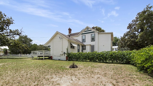 119 E Live Oak Ave, Defuniak Springs, FL 32435 - back of house featuring a chimney and a wooden deck