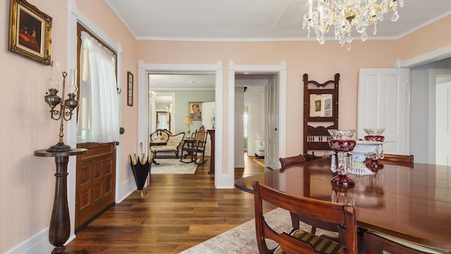 119 E Live Oak Ave, Defuniak Springs, FL 32435 - dining area with dark wood-type flooring, crown molding, baseboards, and a chandelier
