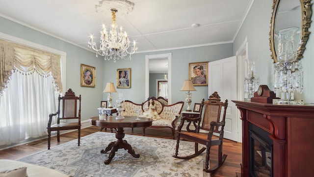 119 E Live Oak Ave, Defuniak Springs, FL 32435 - sitting room featuring wood finished floors, a chandelier, a fireplace, ornamental molding, and baseboards