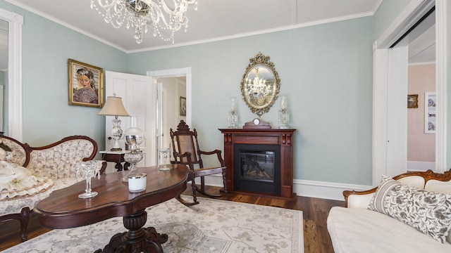 119 E Live Oak Ave, Defuniak Springs, FL 32435 - living room featuring a chandelier, ornamental molding, a glass covered fireplace, dark wood-style floors, and baseboards