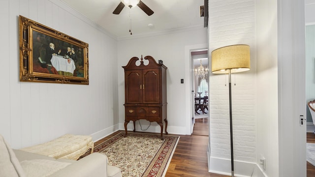 119 E Live Oak Ave, Defuniak Springs, FL 32435 - sitting room featuring dark wood-type flooring, ceiling fan, crown molding, baseboards, and a chandelier