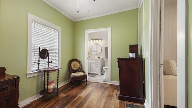 119 E Live Oak Ave, Defuniak Springs, FL 32435 - living area with wood finished floors, crown molding, baseboards, and a ceiling fan