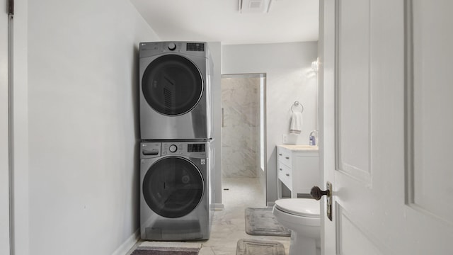 119 E Live Oak Ave, Defuniak Springs, FL 32435 - washroom with stacked washer and clothes dryer and baseboards