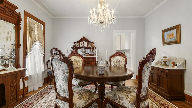 119 E Live Oak Ave, Defuniak Springs, FL 32435 - dining area with wood finished floors, a chandelier, baseboards, and ornamental molding