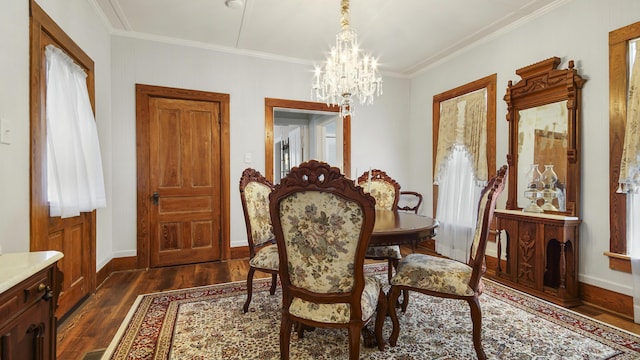 119 E Live Oak Ave, Defuniak Springs, FL 32435 - dining room featuring a chandelier, dark wood-style flooring, crown molding, and baseboards