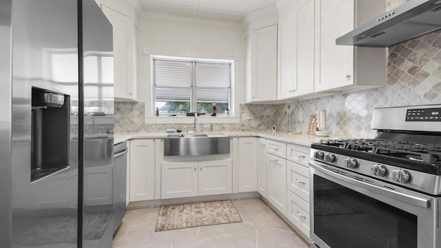119 E Live Oak Ave, Defuniak Springs, FL 32435 - kitchen featuring appliances with stainless steel finishes, under cabinet range hood, a sink, light countertops, and decorative backsplash