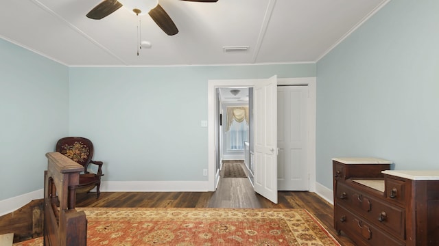 119 E Live Oak Ave, Defuniak Springs, FL 32435 - bedroom featuring dark wood-type flooring, crown molding, baseboards, and ceiling fan