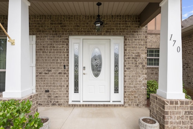 170 Windchime Way, Freeport, FL 32439 - doorway to property with a porch and brick siding