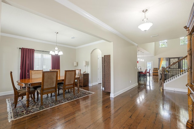 170 Windchime Way, Freeport, FL 32439 - dining room with a chandelier, arched walkways, dark wood-type flooring, stairs, and ornamental molding