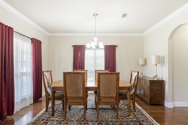 170 Windchime Way, Freeport, FL 32439 - dining space featuring a chandelier, arched walkways, wood finished floors, crown molding, and baseboards