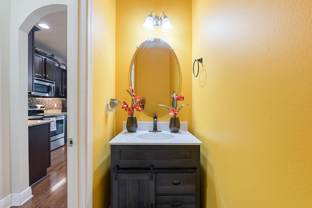 170 Windchime Way, Freeport, FL 32439 - bathroom featuring vanity, backsplash, and wood finished floors