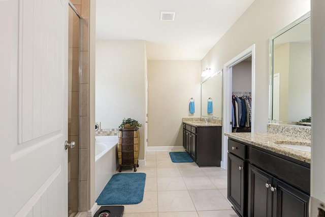 170 Windchime Way, Freeport, FL 32439 - bathroom featuring two vanities, a garden tub, tile patterned floors, and a shower stall