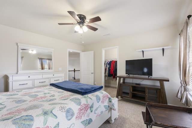 170 Windchime Way, Freeport, FL 32439 - bedroom featuring light colored carpet, a walk in closet, a closet, ceiling fan, and baseboards